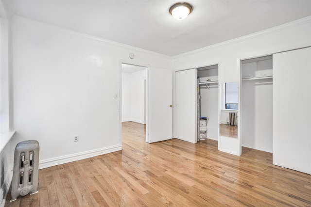 315 56th St Unit C1, West New York, NJ 07093 - unfurnished bedroom with two closets, light wood-style floors, and ornamental molding