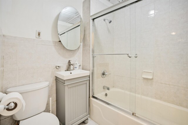 315 56th St Unit C1, West New York, NJ 07093 - full bath featuring vanity, tile walls, and bath / shower combo with glass door