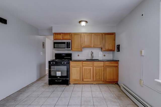 kitchen featuring sink, light tile patterned floors, baseboard heating, black gas range oven, and backsplash