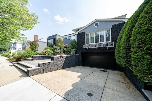 166 W 37th St, Bayonne, NJ 07086 - view of patio / terrace featuring driveway and an attached garage