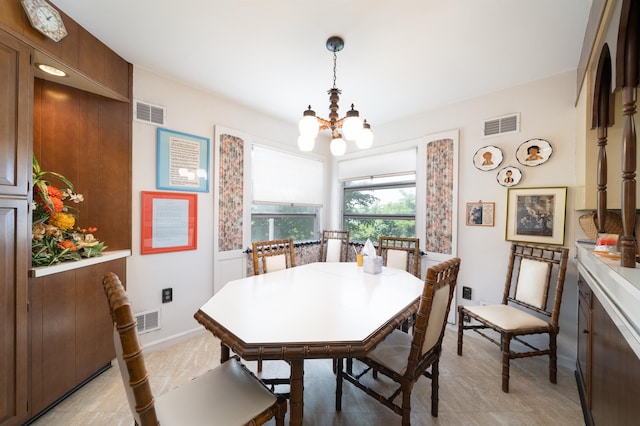 166 W 37th St, Bayonne, NJ 07086 - dining space featuring a chandelier and baseboards
