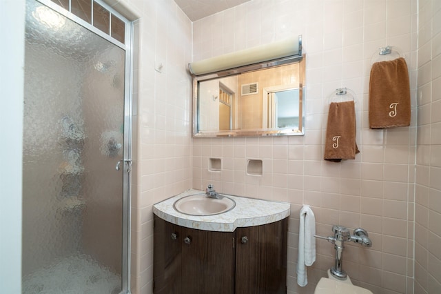 166 W 37th St, Bayonne, NJ 07086 - full bathroom featuring tile walls, a shower stall, and vanity