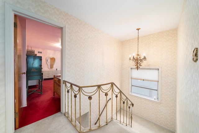 166 W 37th St, Bayonne, NJ 07086 - hallway featuring a chandelier, wallpapered walls, and carpet