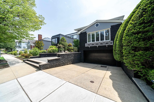 166 W 37th St, Bayonne, NJ 07086 - view of front of property with concrete driveway and a garage