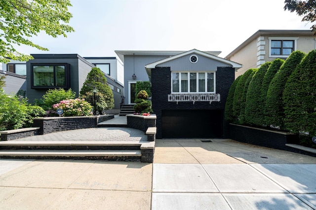 166 W 37th St, Bayonne, NJ 07086 - view of front of property featuring a garage and concrete driveway