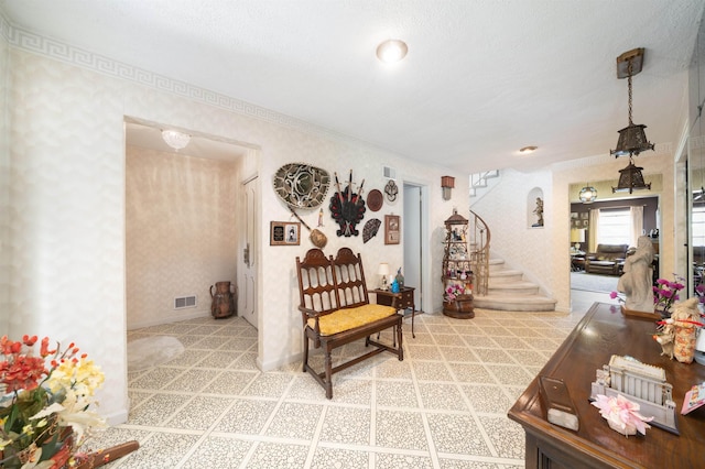 166 W 37th St, Bayonne, NJ 07086 - carpeted living area with stairs, wallpapered walls, and crown molding