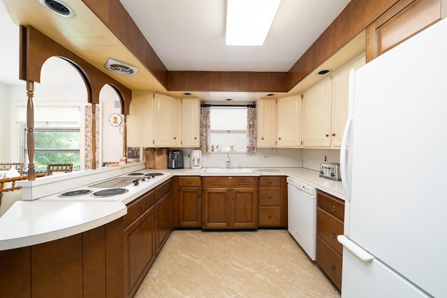166 W 37th St, Bayonne, NJ 07086 - kitchen with white appliances, light countertops, and brown cabinetry