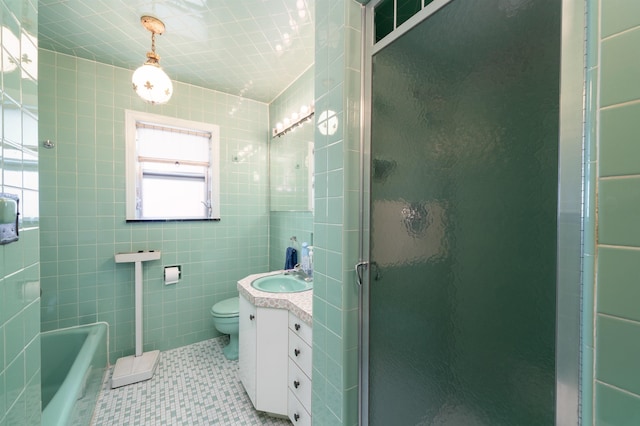 166 W 37th St, Bayonne, NJ 07086 - full bathroom with vanity, a stall shower, tile patterned flooring, tile walls, and a tub