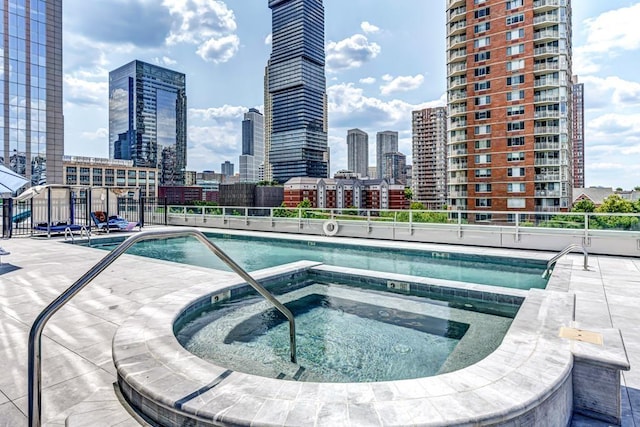 2 2nd St Unit 3805-1, Jersey City, NJ 07302 - view of pool with a view of skyline, fence, and a community hot tub