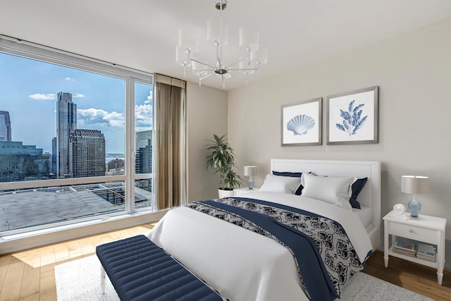 2 2nd St Unit 3805-1, Jersey City, NJ 07302 - bedroom with a chandelier, wood-type flooring, a city view, and a wall of windows