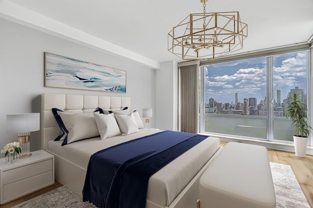 2 2nd St Unit 3805-1, Jersey City, NJ 07302 - bedroom featuring a chandelier, wood finished floors, and a view of skyline