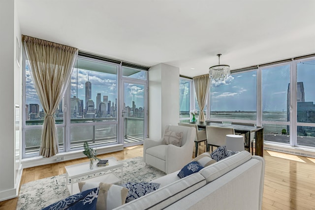 2 2nd St Unit 3805-1, Jersey City, NJ 07302 - living room with a chandelier, floor to ceiling windows, healthy amount of natural light, a skyline view, and wood finished floors