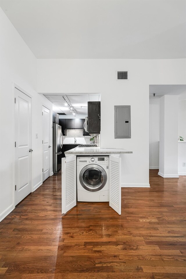 347 Varick St Unit 114A, Jersey City, NJ 07302 - laundry area with washer / clothes dryer, electric panel, dark wood finished floors, and baseboards