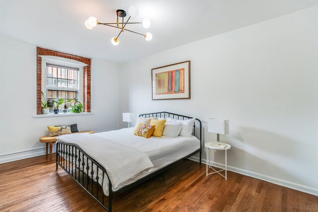 347 Varick St Unit 114A, Jersey City, NJ 07302 - bedroom featuring baseboards, wood finished floors, and a chandelier