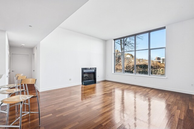8100 River Rd Unit 0107, North Bergen, NJ 07047 - unfurnished living room featuring a high end fireplace, wood finished floors, and baseboards
