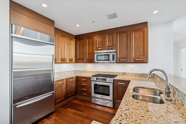 8100 River Rd Unit 0107, North Bergen, NJ 07047 - kitchen featuring stainless steel appliances, a sink, dark wood-style floors, light stone counters, and recessed lighting