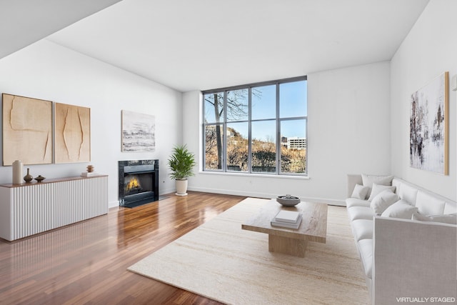 8100 River Rd Unit 0107, North Bergen, NJ 07047 - living area featuring wood finished floors, a fireplace, and baseboards