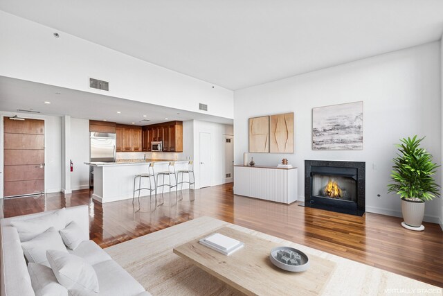 8100 River Rd Unit 0107, North Bergen, NJ 07047 - living area with wood finished floors, a fireplace with flush hearth, recessed lighting, and baseboards