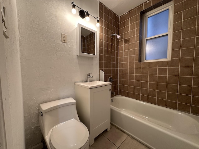 full bathroom with tile patterned flooring, vanity, tiled shower / bath combo, and toilet