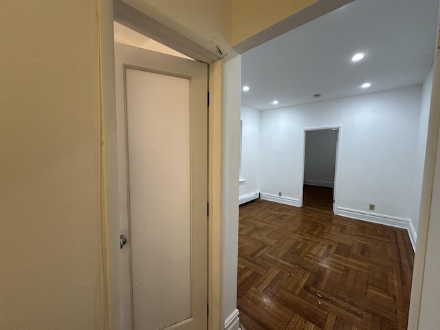 corridor featuring dark parquet flooring