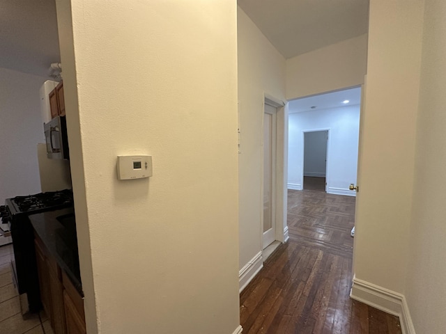 hall with dark wood-type flooring