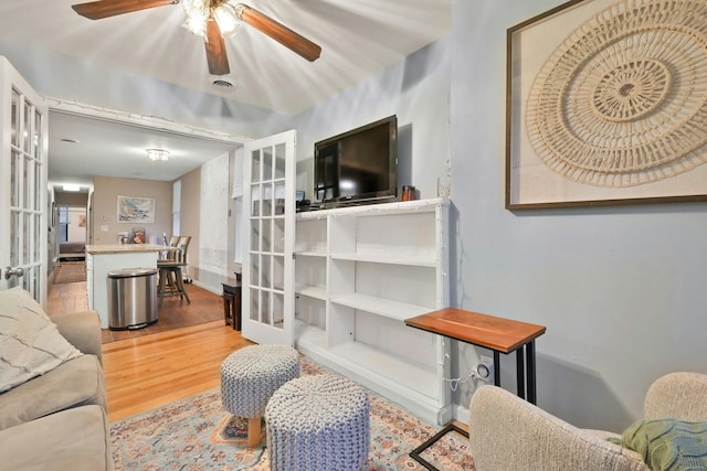 living room featuring french doors and light hardwood / wood-style floors