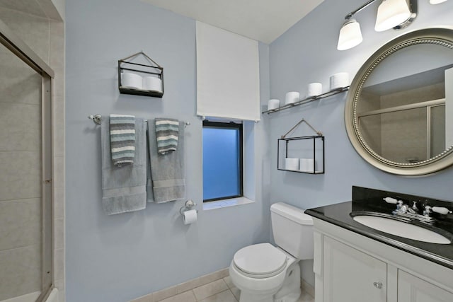 bathroom with toilet, a shower with door, vanity, and tile patterned floors