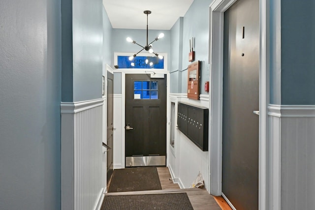 entryway with a chandelier and wood-type flooring