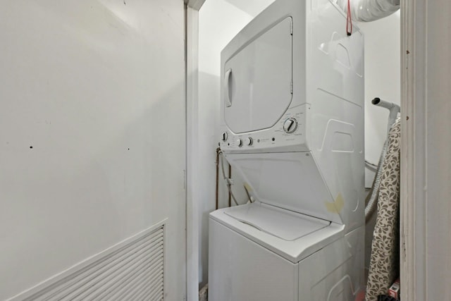 laundry area with stacked washer and dryer