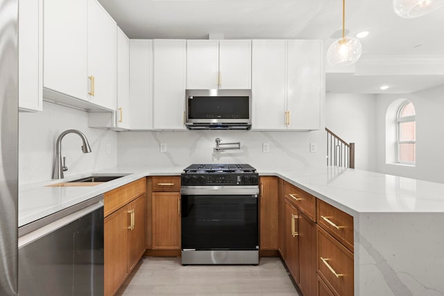 133 Clifton Pl Unit 2, Jersey City, NJ 07304 - kitchen featuring stainless steel appliances, a peninsula, light wood finished floors, tasteful backsplash, and brown cabinetry
