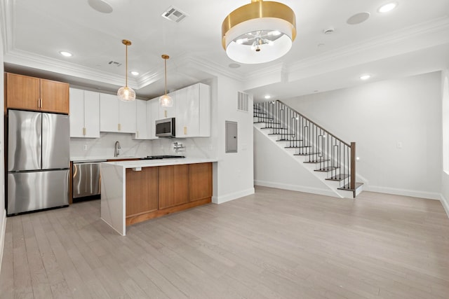 133 Clifton Pl Unit 2, Jersey City, NJ 07304 - kitchen with stainless steel appliances, light wood finished floors, ornamental molding, light countertops, and electric panel