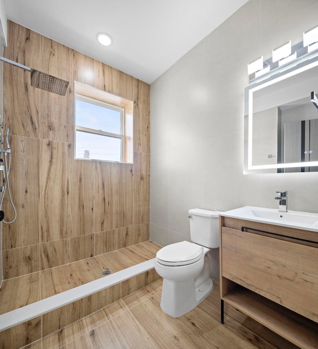 133 Clifton Pl Unit 2, Jersey City, NJ 07304 - bathroom featuring tiled shower, vanity, and tile walls