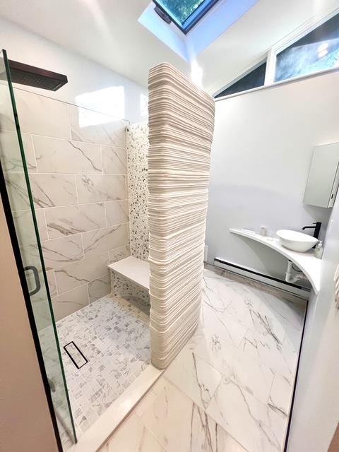 203 Stanhope Rd, Sparta, NJ 07871 - bathroom with a skylight, a stall shower, and marble look tile flooring