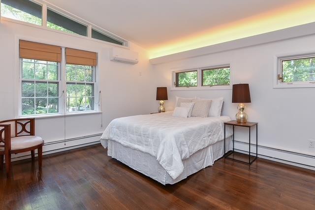 203 Stanhope Rd, Sparta, NJ 07871 - bedroom with a baseboard radiator, lofted ceiling, wood finished floors, a baseboard heating unit, and a wall mounted air conditioner