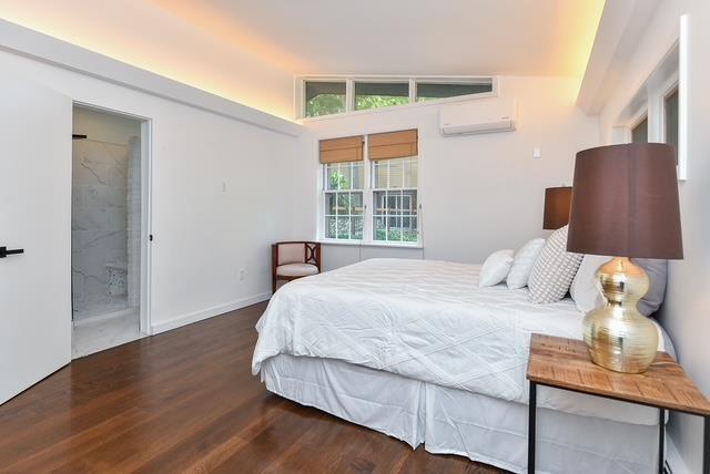 203 Stanhope Rd, Sparta, NJ 07871 - bedroom featuring a wall unit AC and wood finished floors