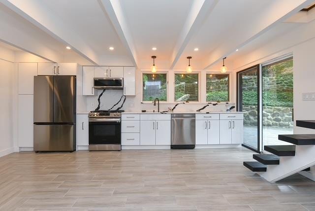 203 Stanhope Rd, Sparta, NJ 07871 - kitchen featuring appliances with stainless steel finishes, light countertops, white cabinets, tasteful backsplash, and recessed lighting