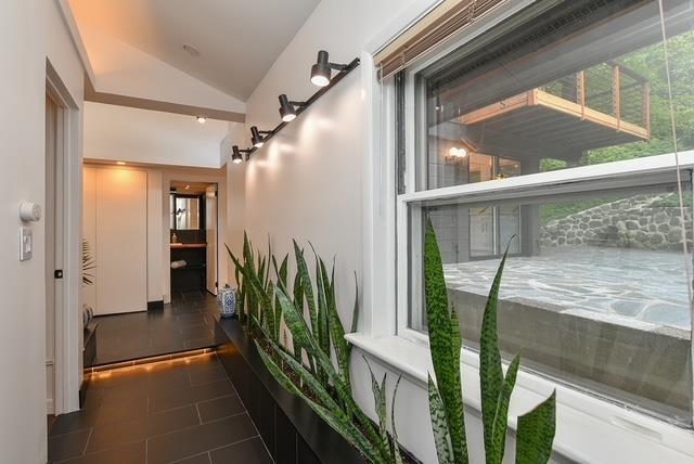 203 Stanhope Rd, Sparta, NJ 07871 - hallway with vaulted ceiling, dark tile patterned flooring, and healthy amount of natural light