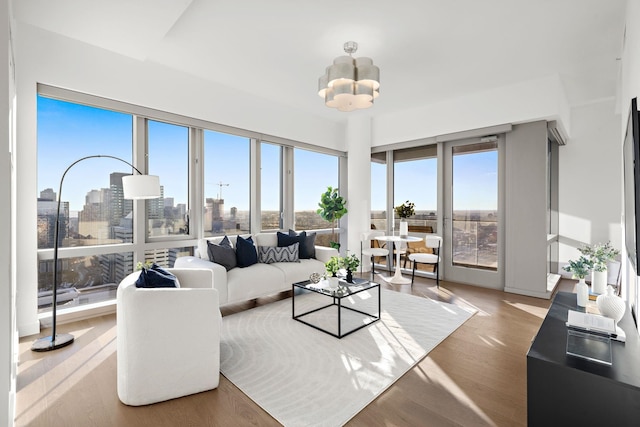 living room with an inviting chandelier and wood-type flooring