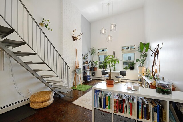212 9th St Unit 4B, Jersey City, NJ 07302 - foyer featuring a baseboard radiator, a towering ceiling, stairway, and baseboard heating