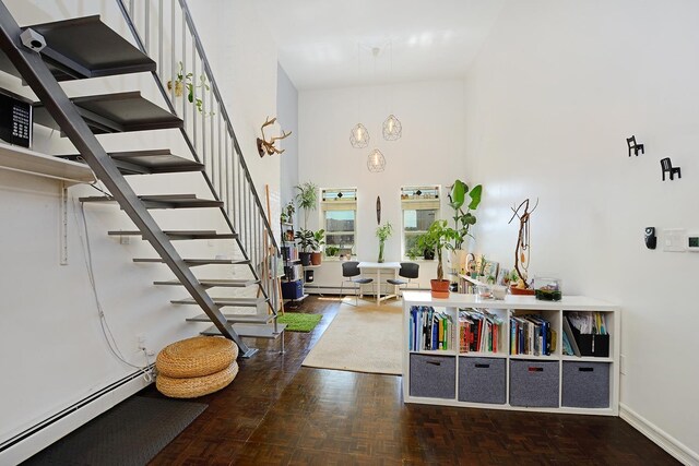 212 9th St Unit 4B, Jersey City, NJ 07302 - entrance foyer featuring a baseboard radiator, stairway, a towering ceiling, and baseboards