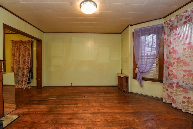 spare room with dark hardwood / wood-style floors and ornamental molding