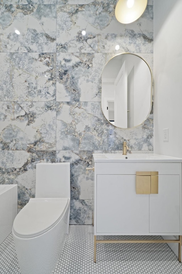 bathroom with vanity, tile patterned flooring, and toilet