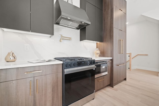 kitchen featuring lofted ceiling, decorative backsplash, exhaust hood, light hardwood / wood-style floors, and gas stove