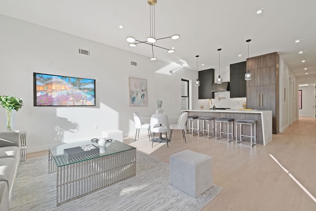 living room with sink and light hardwood / wood-style flooring