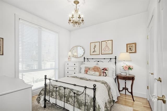 414 1st St Unit 1, Jersey City, NJ 07302 - bedroom featuring a chandelier and light wood finished floors