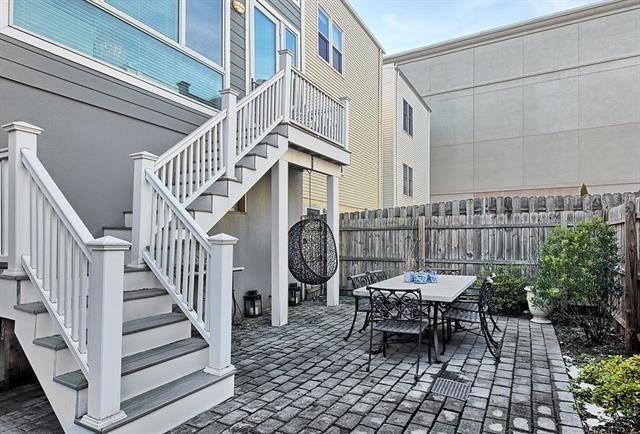 414 1st St Unit 1, Jersey City, NJ 07302 - fenced backyard featuring stairway, a patio area, and outdoor dining area