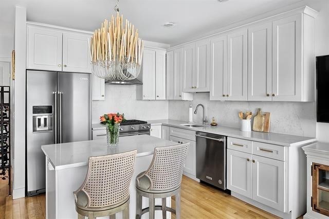 414 1st St Unit 1, Jersey City, NJ 07302 - kitchen featuring appliances with stainless steel finishes, light wood-type flooring, white cabinets, and light countertops