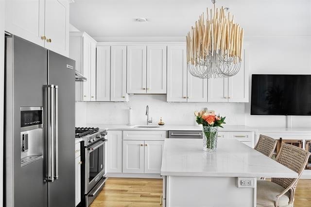414 1st St Unit 1, Jersey City, NJ 07302 - kitchen featuring high end appliances, a chandelier, light countertops, and light wood-type flooring