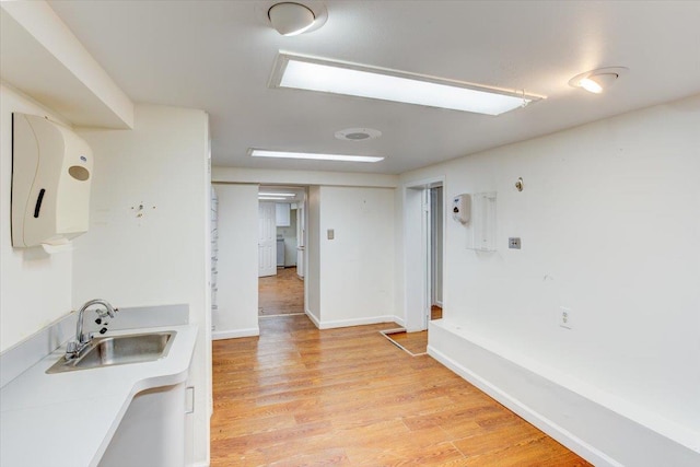 kitchen featuring light wood-type flooring and sink