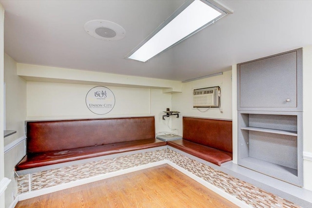 interior space featuring wood-type flooring and a wall mounted air conditioner